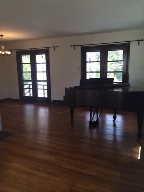 4843 Baptist Road Whitehall, PA 15227 - Photo 9 of 16 Living Room. A large living room and dining room open space, highlighted by the warm fireplace. The baby grand piano is a highlight in the room.