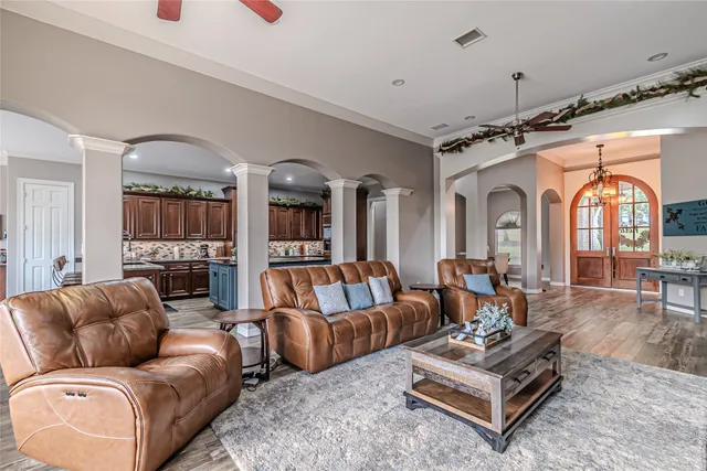 a living room with furniture a rug and a chandelier