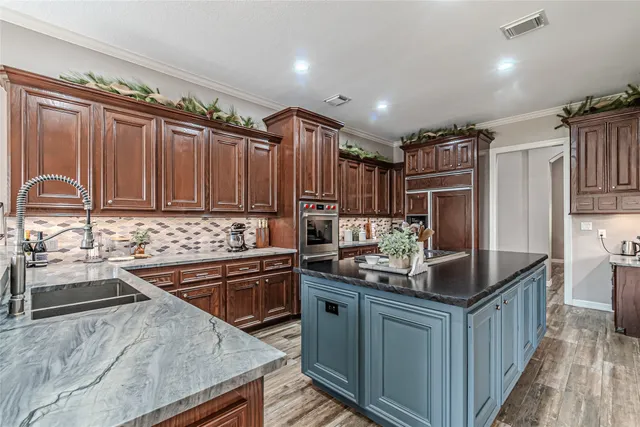 a kitchen with stainless steel appliances granite countertop a sink stove and refrigerator
