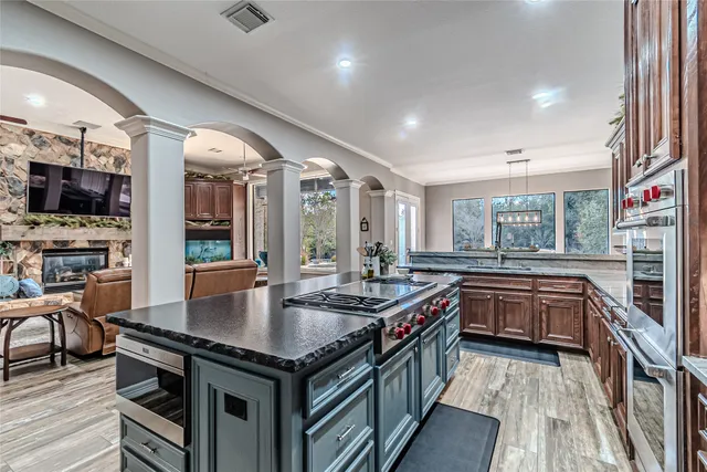 a kitchen with stainless steel appliances granite countertop a stove and a refrigerator