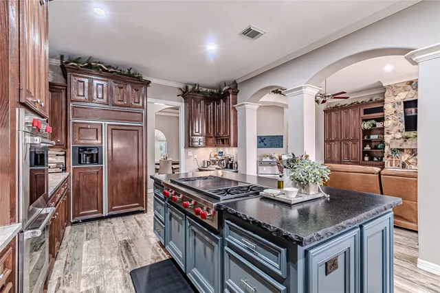 a kitchen with stainless steel appliances granite countertop a stove and a refrigerator