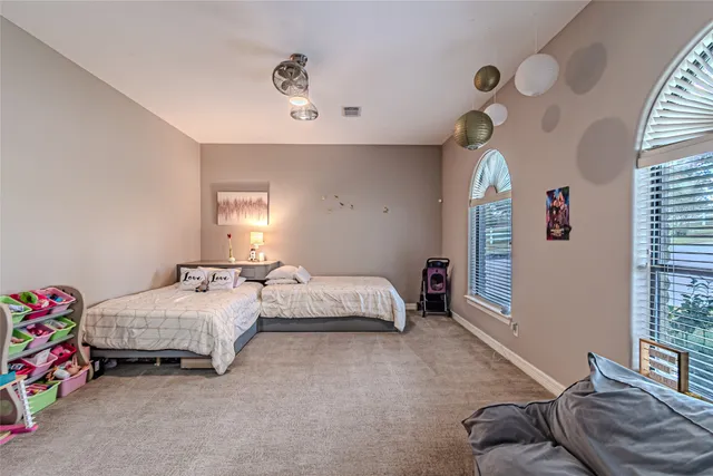 a bedroom with bed and window