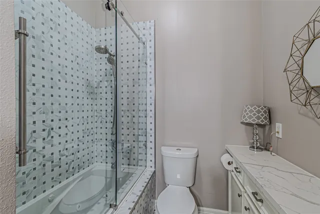 a bathroom with a toilet and a shower curtain