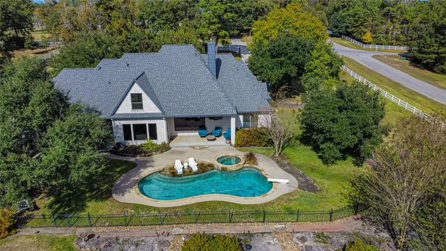 a aerial view of a house with yard patio and green space