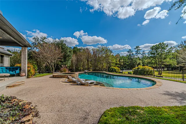 a view of a swimming pool with an outdoor seating and a yard