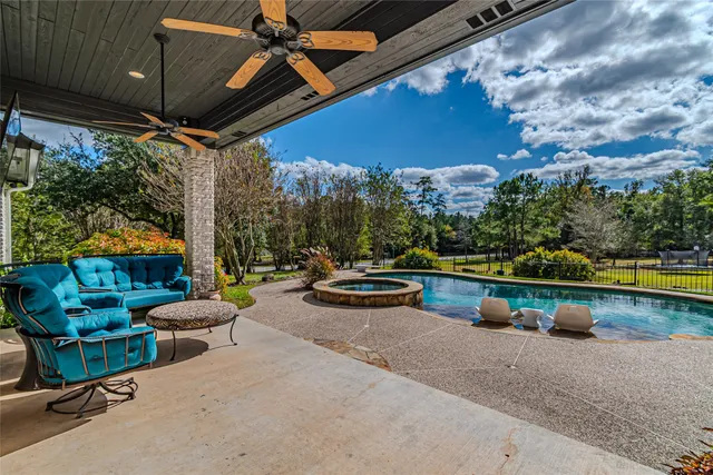 a view of swimming pool with outdoor seating and a yard