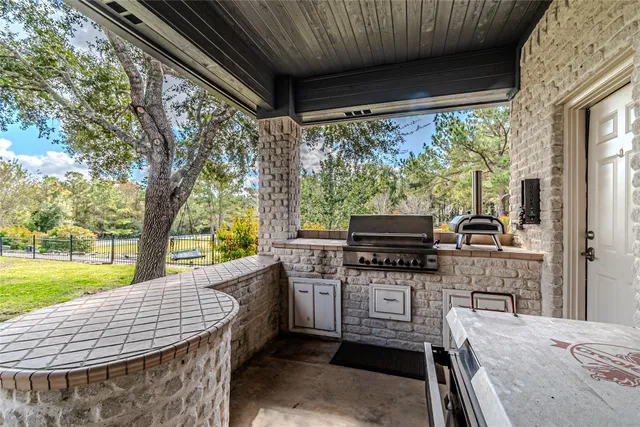 a view of a patio with table and chairs potted plants with wooden fence