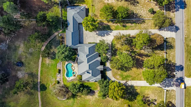 an aerial view of a house with a yard swimming pool and outdoor seating