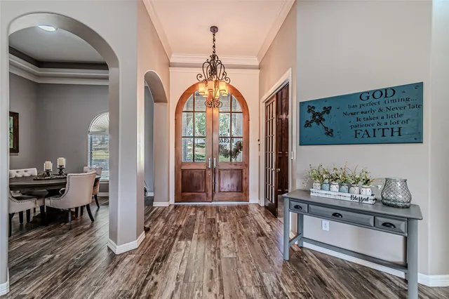 a very nice looking room with wooden floor and furniture