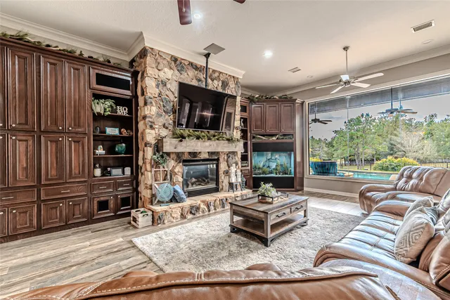 a living room with furniture a fireplace and a flat screen tv