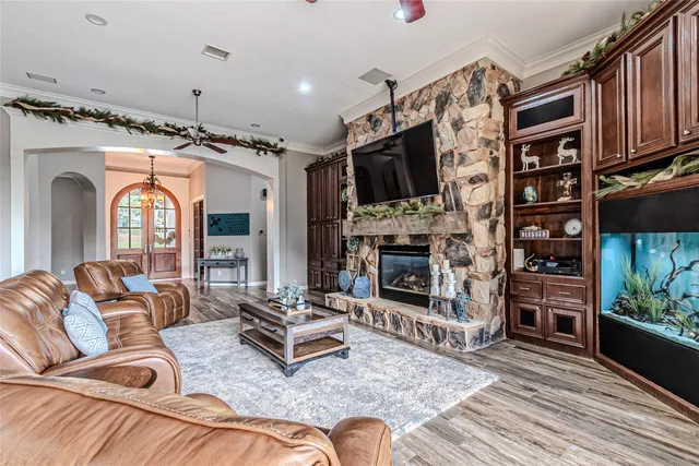 a living room with fireplace furniture and a flat screen tv