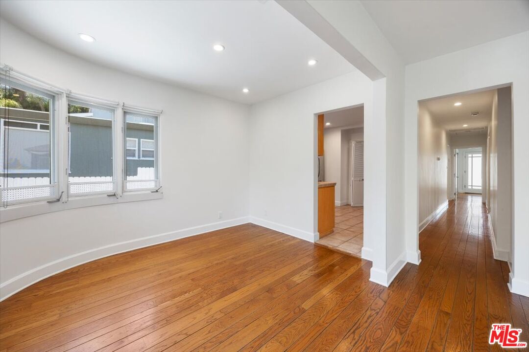14041 Roblar Road Sherman Oaks, CA 91423 - Photo 12 of 47 a view of an empty room with wooden floor and a window