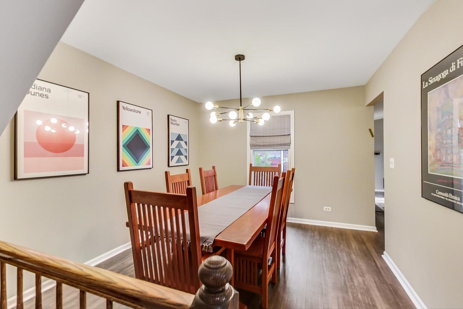 9024 Forestview Road Evanston, IL 60203 - Photo 13 of 41 a view of a dining room with furniture a chandelier and wooden floor