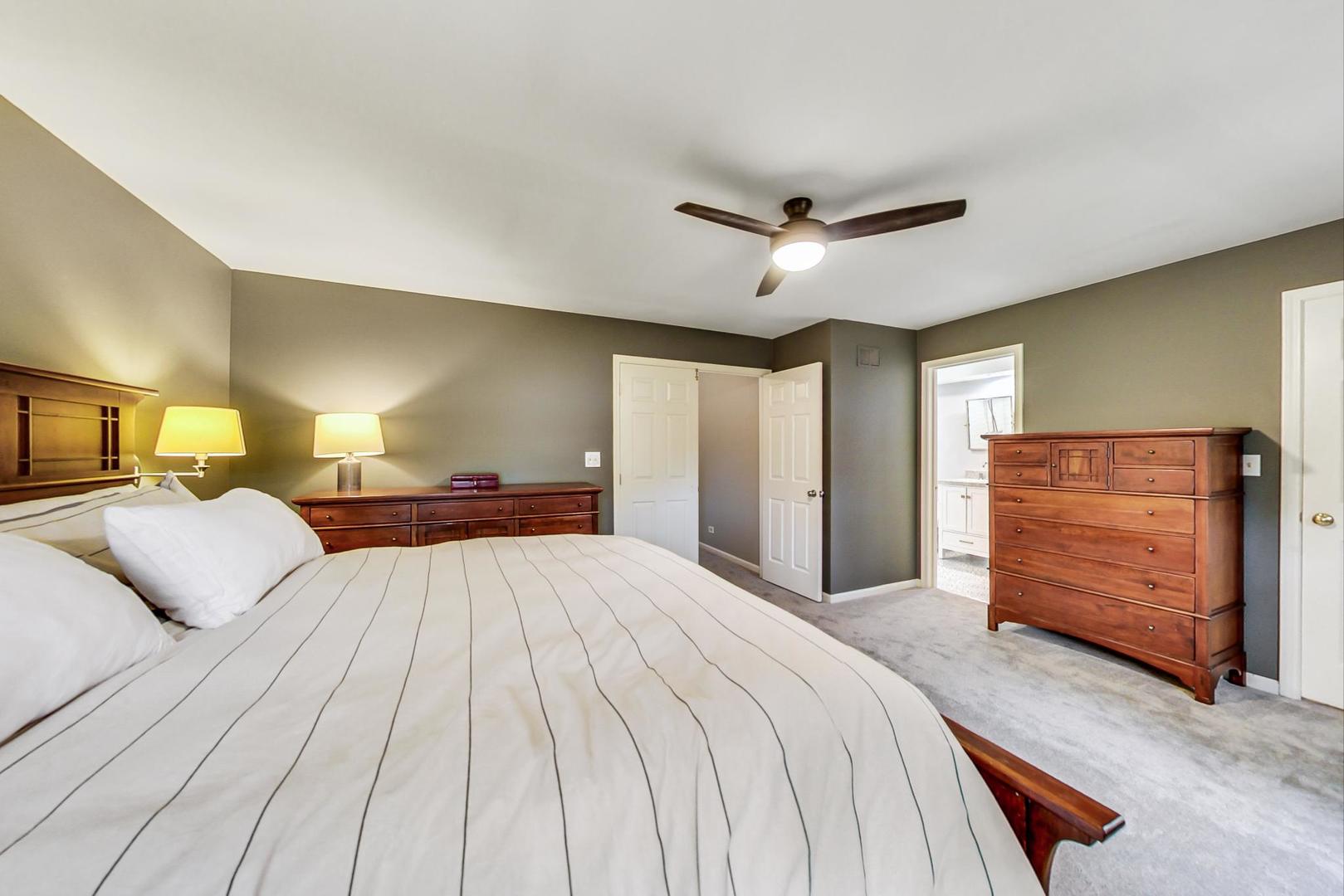 9024 Forestview Road Evanston, IL 60203 - Photo 20 of 41 a bedroom with a large bed and a chandelier