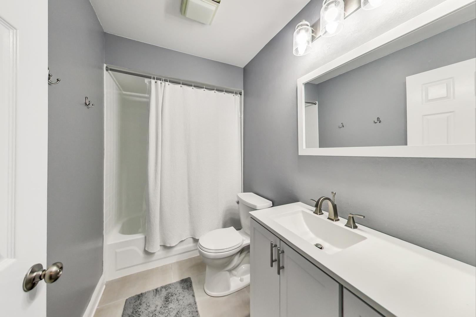 9024 Forestview Road Evanston, IL 60203 - Photo 28 of 41 a bathroom with a toilet sink and mirror