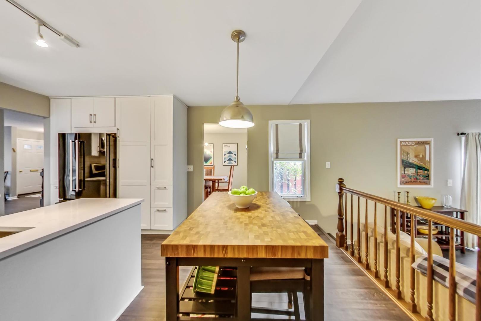 9024 Forestview Road Evanston, IL 60203 - Photo 9 of 41 a view of a kitchen with dining table and chandelier