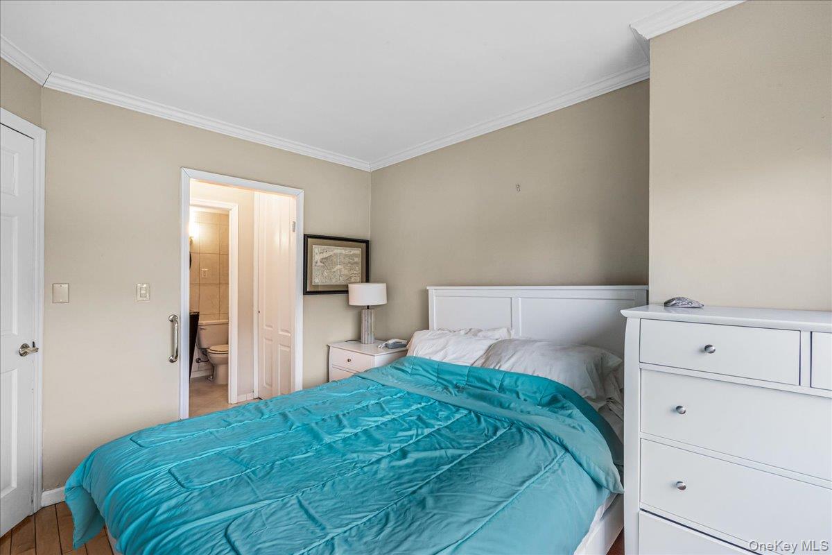 220-55 46th Avenue, Unit 5P Queens, NY 11361 - Photo 12 of 24 a bedroom with a bed and closet