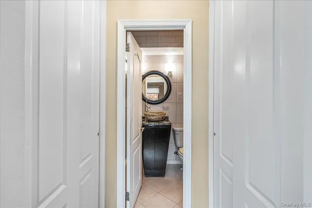 a view of a hallway with wooden floor and closet