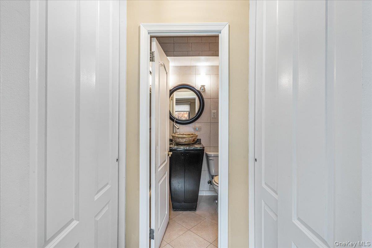 220-55 46th Avenue, Unit 5P Queens, NY 11361 - Photo 14 of 24 a view of a hallway with wooden floor and closet