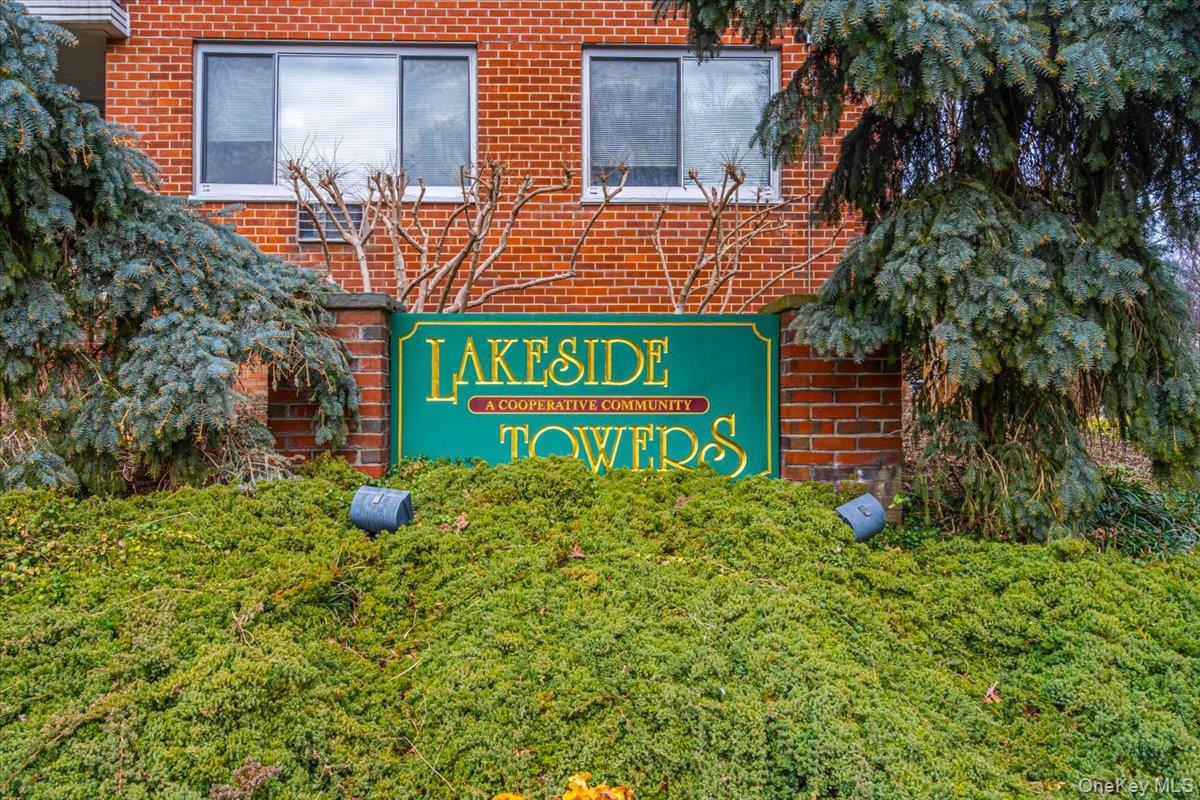 220-55 46th Avenue, Unit 5P Queens, NY 11361 - Photo 16 of 24 a sign that is sitting in front of a brick building