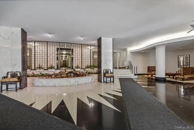 a large living room with dining table and chairs