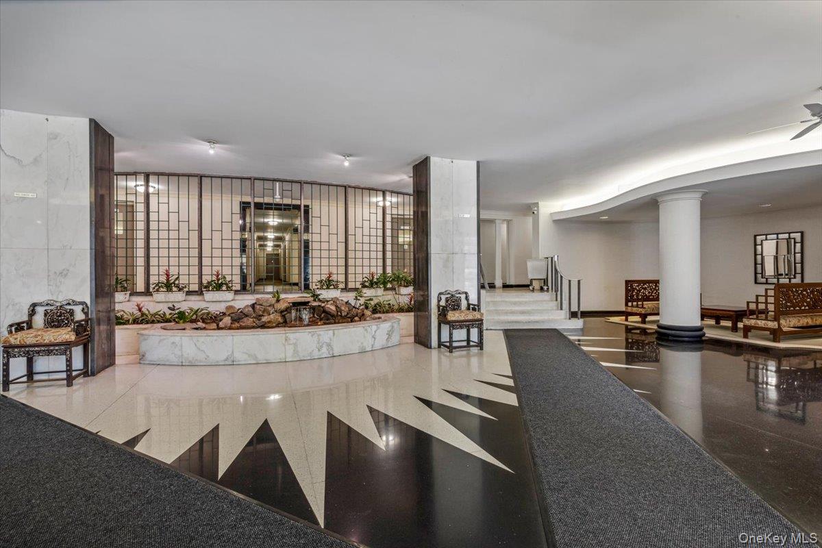 220-55 46th Avenue, Unit 5P Queens, NY 11361 - Photo 20 of 24 a large living room with dining table and chairs