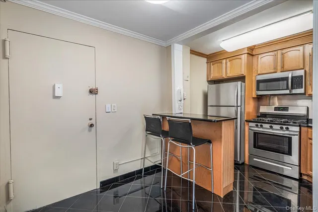 a kitchen with stainless steel appliances a refrigerator and a stove top oven
