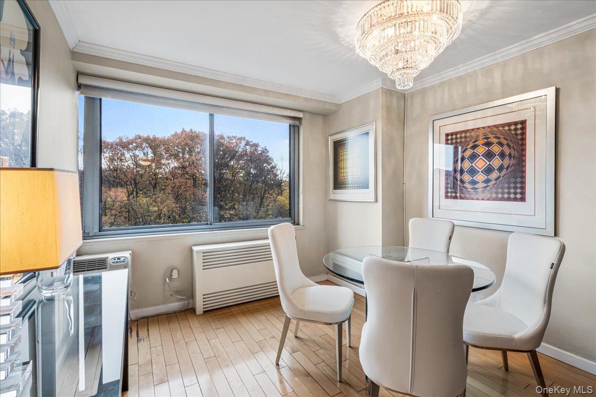 220-55 46th Avenue, Unit 5P Queens, NY 11361 - Photo 9 of 24 a view of a dining room with furniture a chandelier and wooden floor
