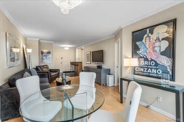 a living room with furniture a flat screen tv and kitchen view