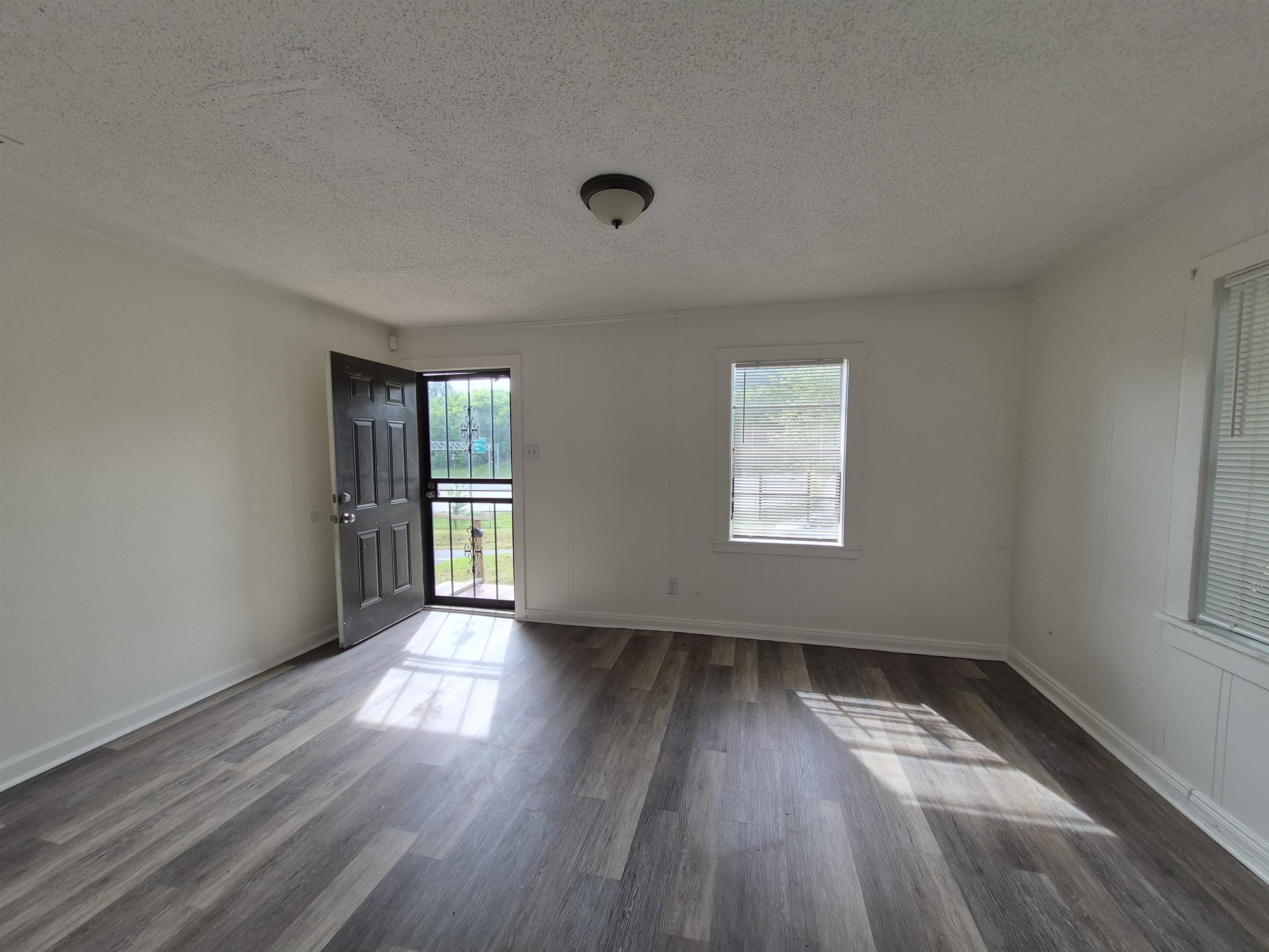 2100 Riverside Boulevard Memphis, TN 38109 - Photo 2 of 10 an empty room with wooden floor and windows