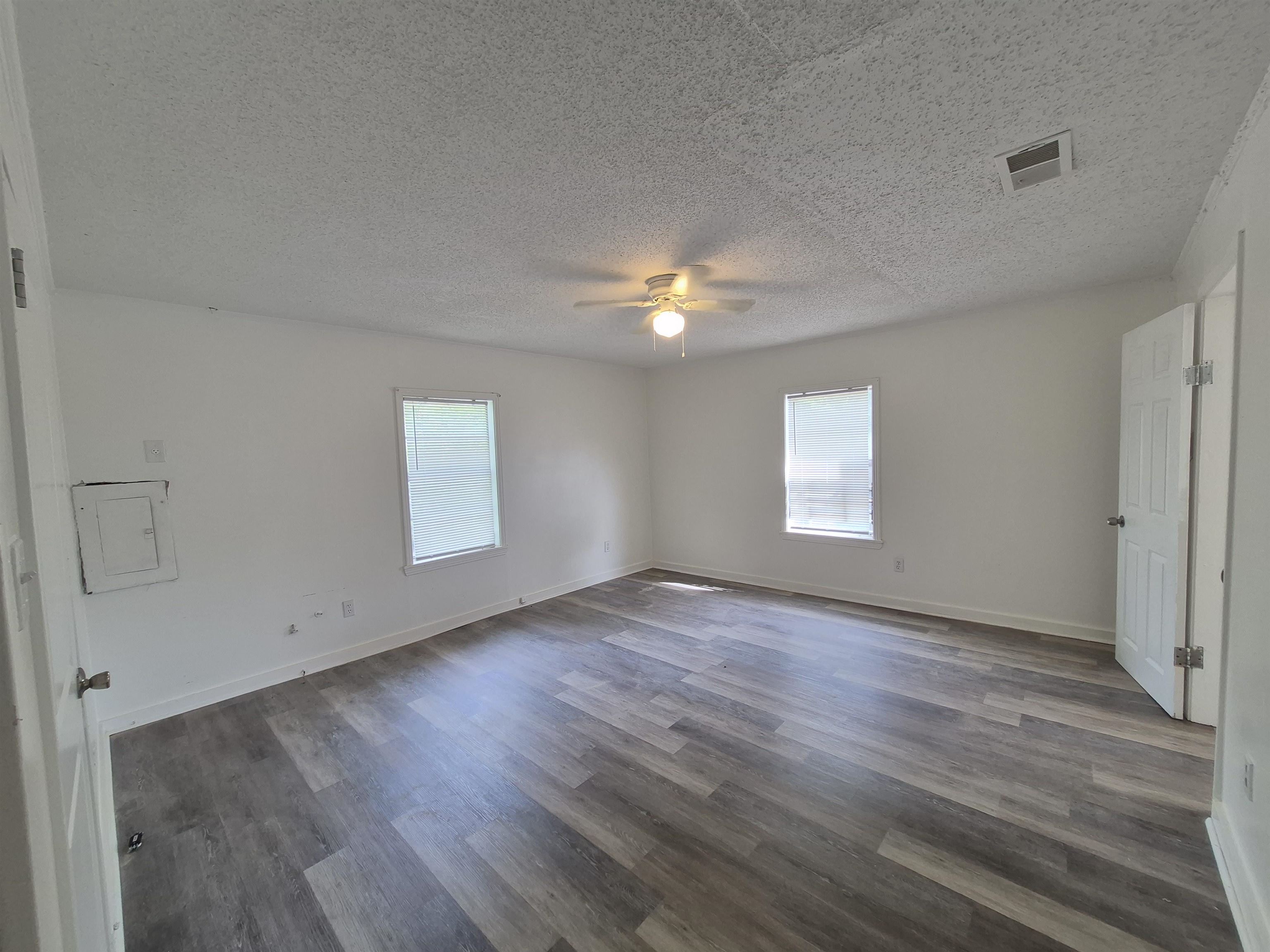2100 Riverside Boulevard Memphis, TN 38109 - Photo 6 of 10 an empty room with wooden floor and windows