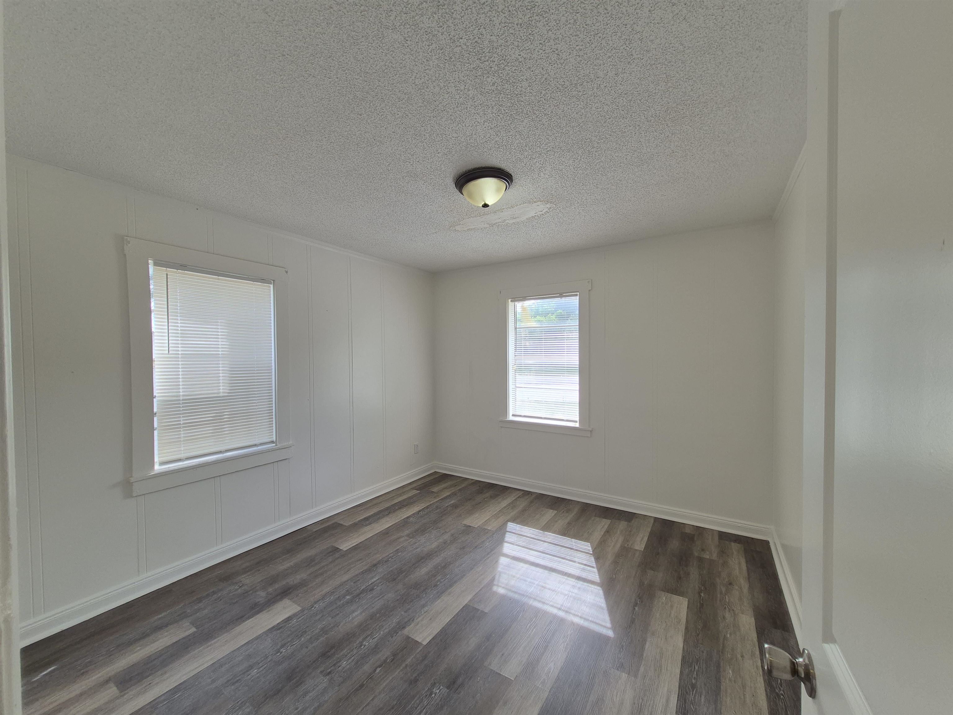 2100 Riverside Boulevard Memphis, TN 38109 - Photo 9 of 10 a view of an empty room with wooden floor and a window