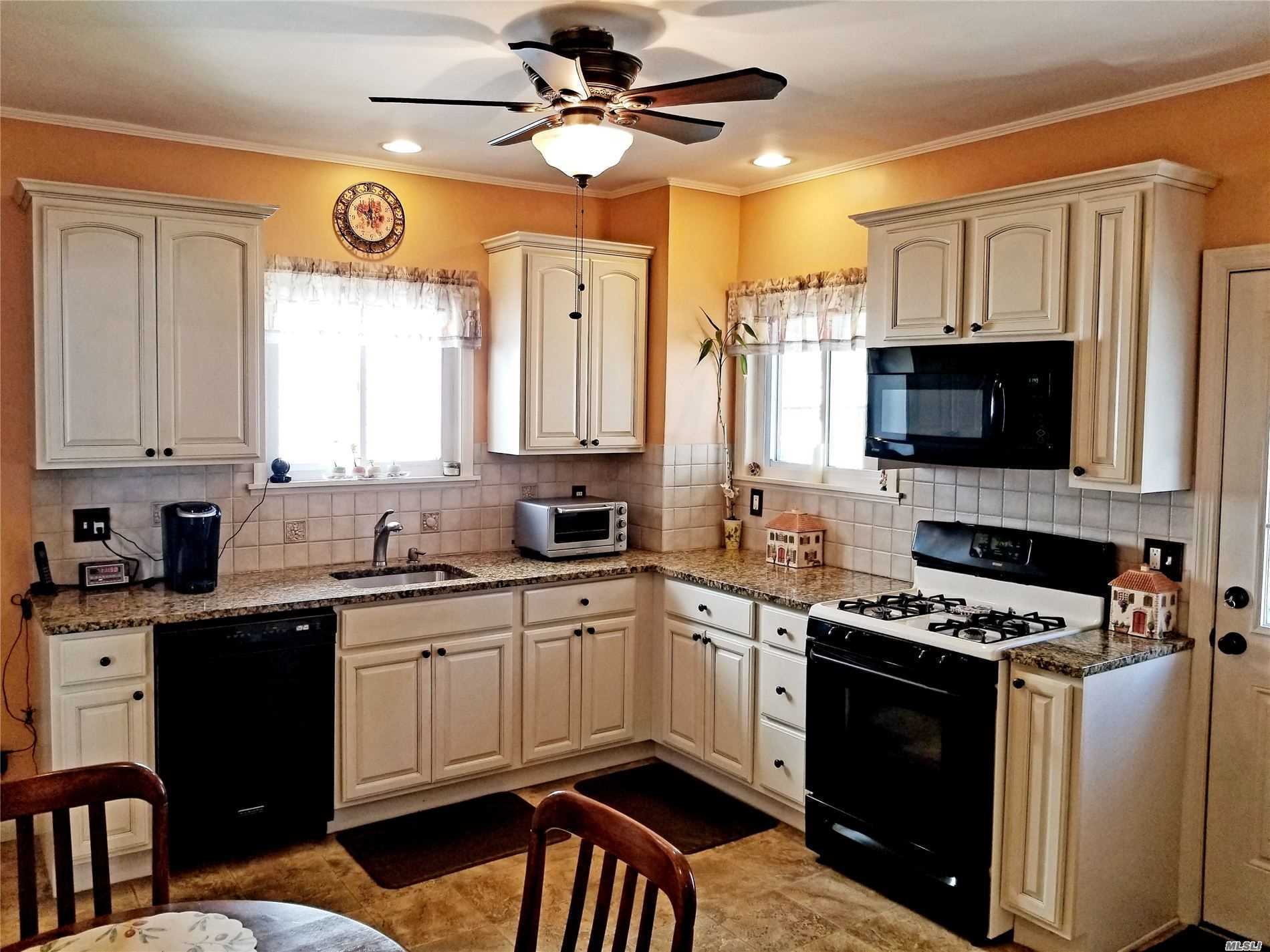a kitchen with a sink stove and microwave