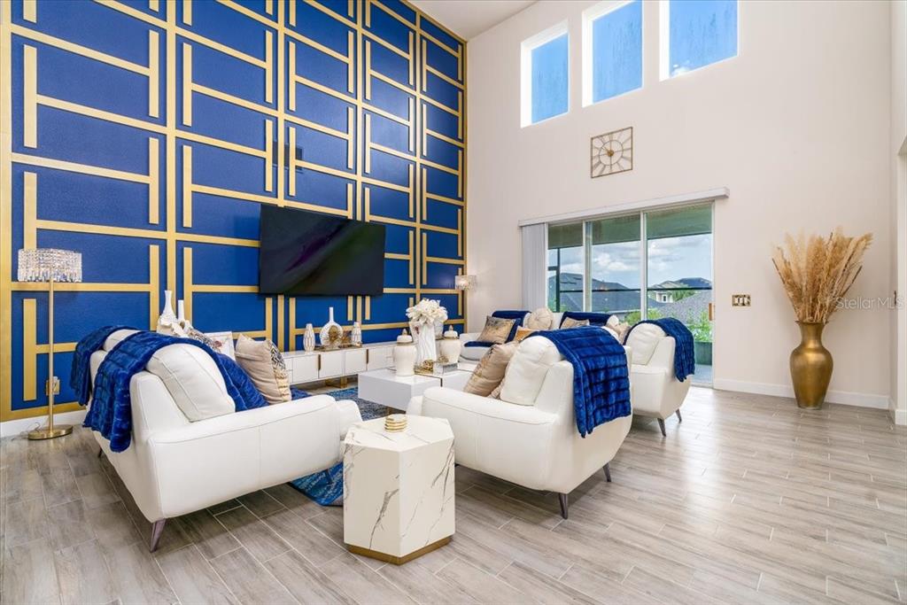 1296 Waterview Ridge Circle Apopka, FL 32703 - Photo 4 of 60 a living room with furniture and a floor to ceiling window