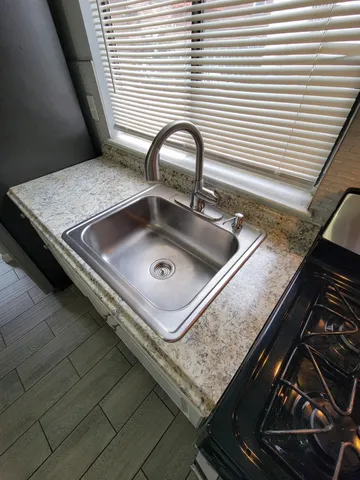 a white toilet sitting next to a bathroom sink