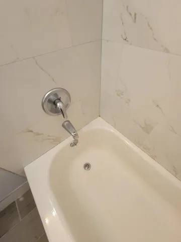 a view of a big room with wooden floor and windows