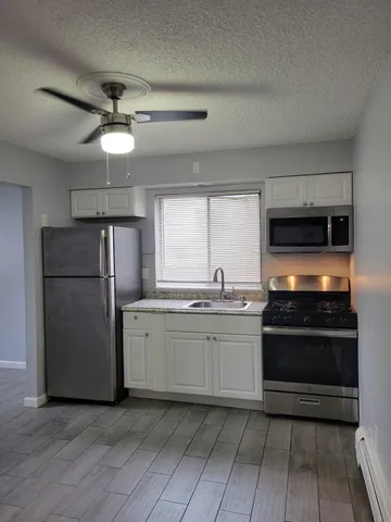 a kitchen with a refrigerator sink and stove