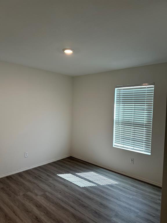5906 Nyquist Way Forney, TX 75126 - Photo 15 of 27 Unfurnished room with wood finished floors and baseboards