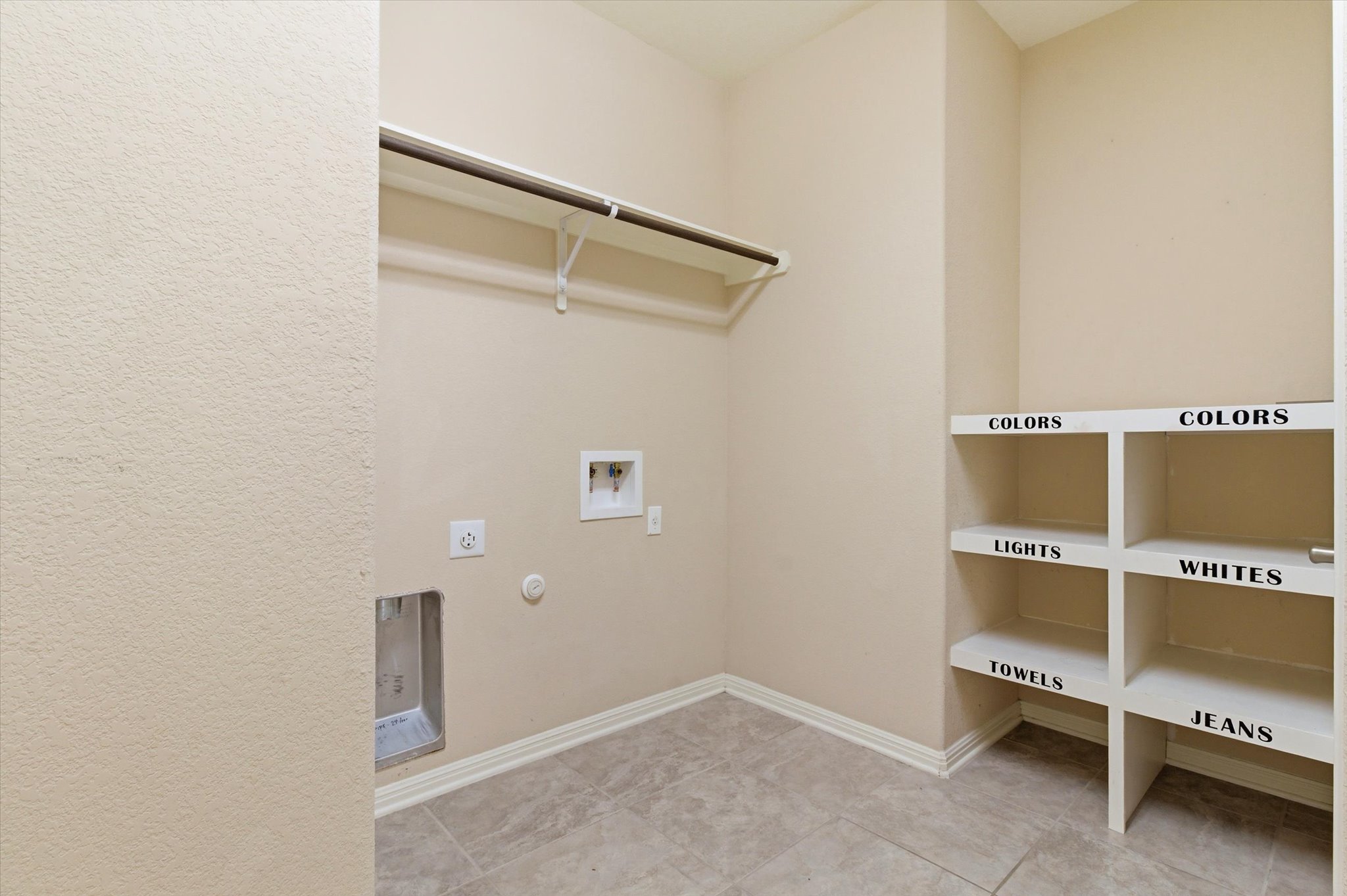 1511 Rimstone Drive Cedar Park, TX 78613 - Photo 30 of 39 A well-organized laundry area offers a convenient hanging rod and practical built-in shelving.