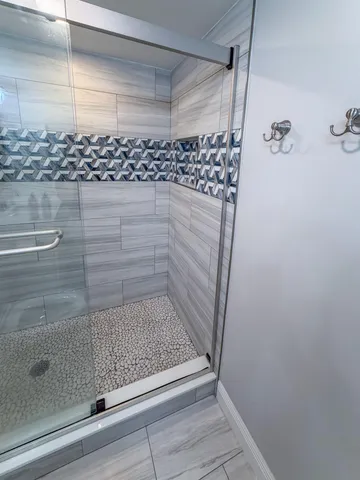 a large living room with furniture or chandelier and a large window