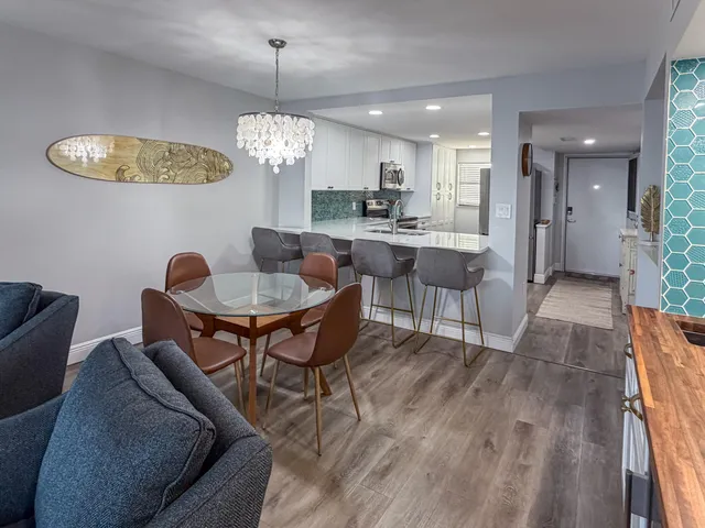 a view of a dining room with furniture and chandelier