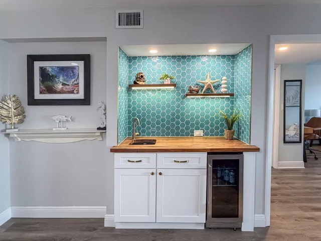 a view of kitchen with granite countertop cabinets and sink