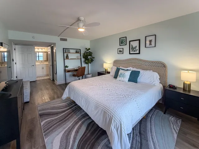 a bedroom with bed and wooden floor