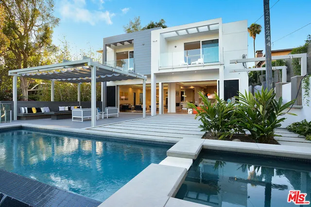a view of a swimming pool with outdoor seating