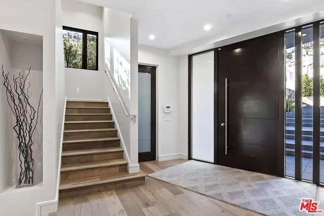 a view of entryway with wooden floor and stairs