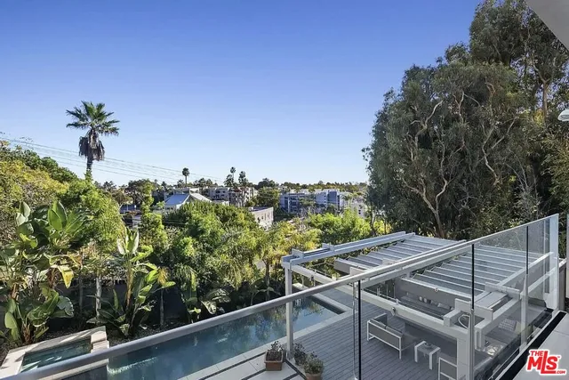 a view of a terrace with chairs and potted plants