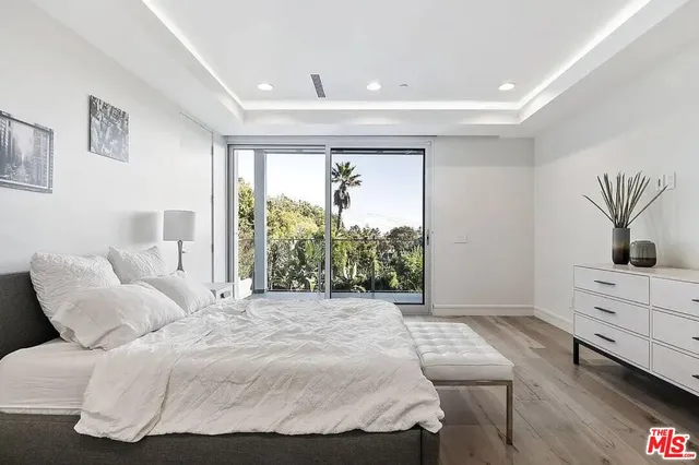 a spacious bedroom with a large bed and a window