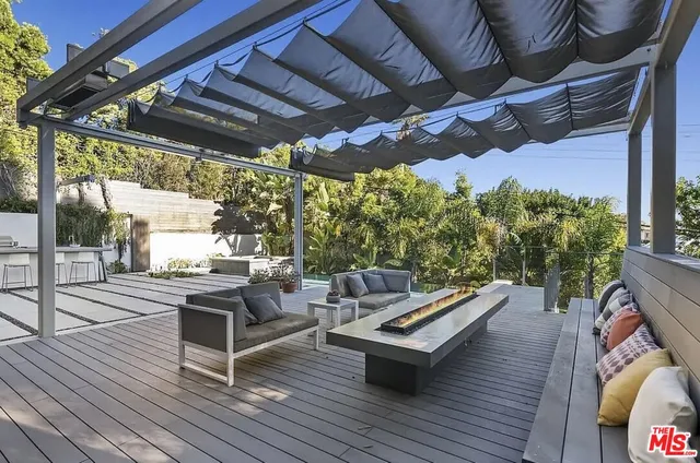 a outdoor living space with furniture and a fireplace