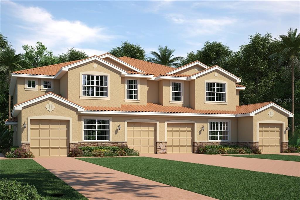 8259 Enclave Way, Unit 101 Sarasota, FL 34243 - Photo 1 of 1 a front view of a house with a yard and garage