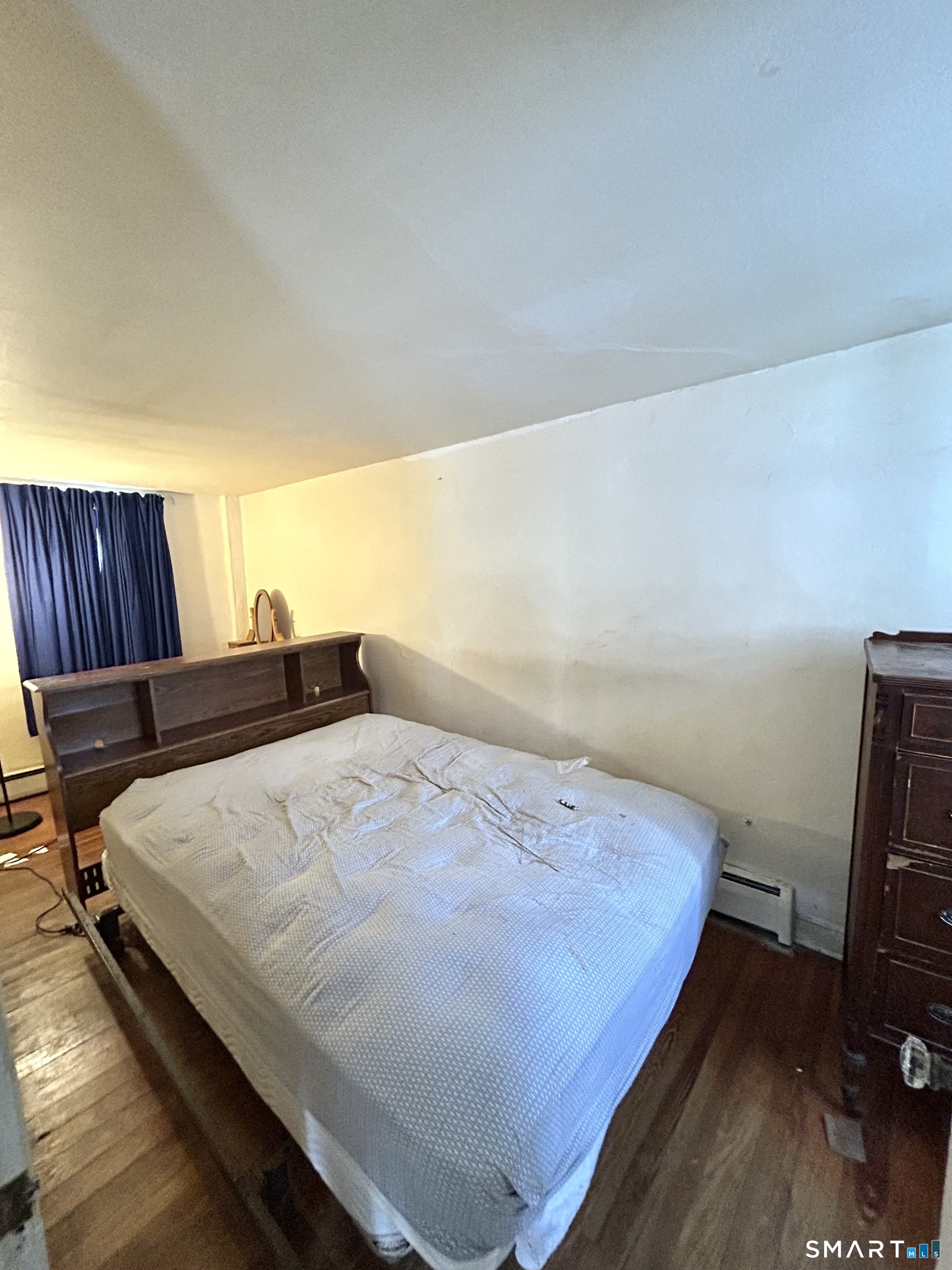 64 Bridge Street Canton, CT 06019 - Photo 12 of 12 a bed sitting in a bedroom next to a window